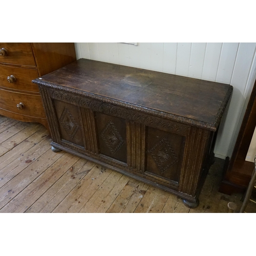 635 - A Victorian Three Panelled Oak Coffer with Gadrooned & Chip Carving resting on Bun Feet. Measuring: ... 