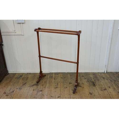 645 - A Victorian design turned Mahogany Towel Rail resting on a shaped base. Measuring: 77cms across x 10... 