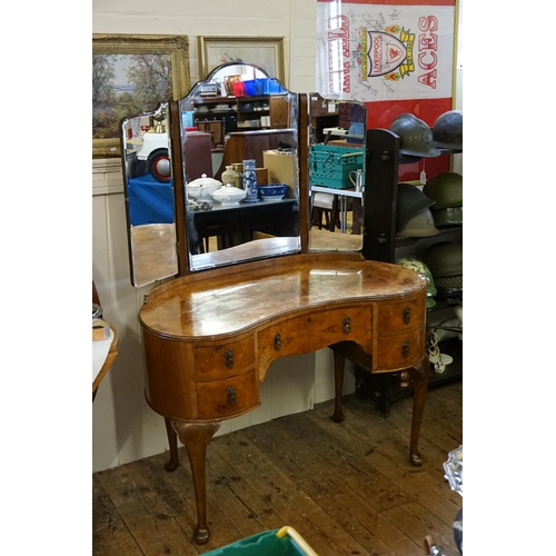 658 - A Burr Walnut Veneered Kidney Shaped Dressing Table with fitted Drawers & Mirror resting on scroll p... 