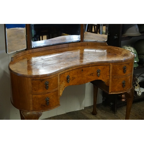 658 - A Burr Walnut Veneered Kidney Shaped Dressing Table with fitted Drawers & Mirror resting on scroll p... 