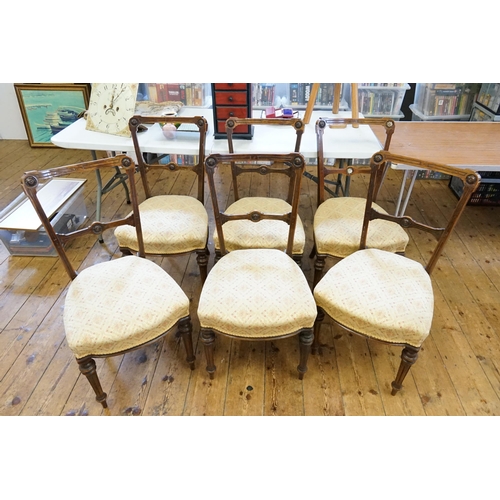 662 - A Set of Six Walnut Hoop Back Dining Chairs with Regency design tapestry seats & resting on turned f... 