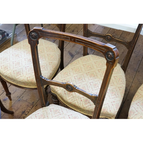 662 - A Set of Six Walnut Hoop Back Dining Chairs with Regency design tapestry seats & resting on turned f... 