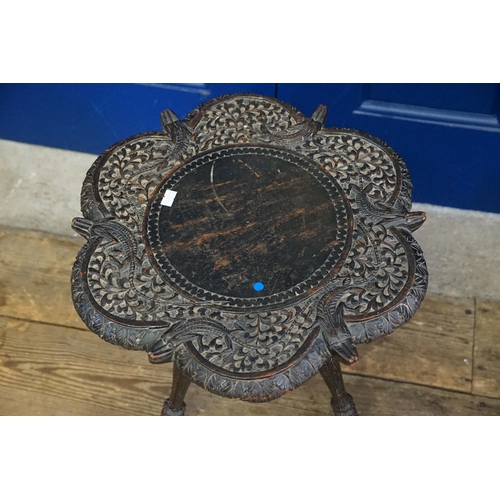 624 - An Indian Carved Hardwood Crocodile decorated Cashmere Tea Table resting on turned legs. Measuring: ... 