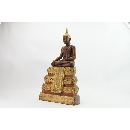 416 - An Asian Carved Wooden Seated Buddha in Wood with Gilt Highlights seated in the Lotus Position on a ... 