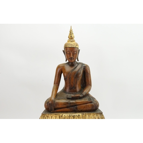 416 - An Asian Carved Wooden Seated Buddha in Wood with Gilt Highlights seated in the Lotus Position on a ... 