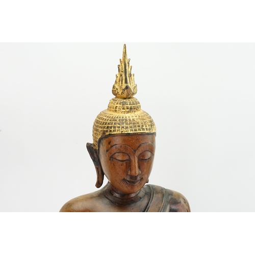 416 - An Asian Carved Wooden Seated Buddha in Wood with Gilt Highlights seated in the Lotus Position on a ... 