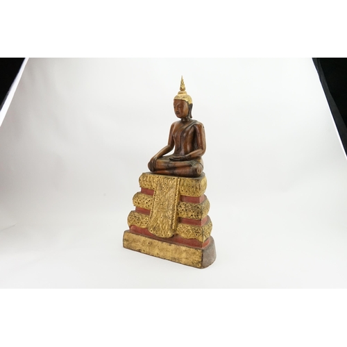 416 - An Asian Carved Wooden Seated Buddha in Wood with Gilt Highlights seated in the Lotus Position on a ... 