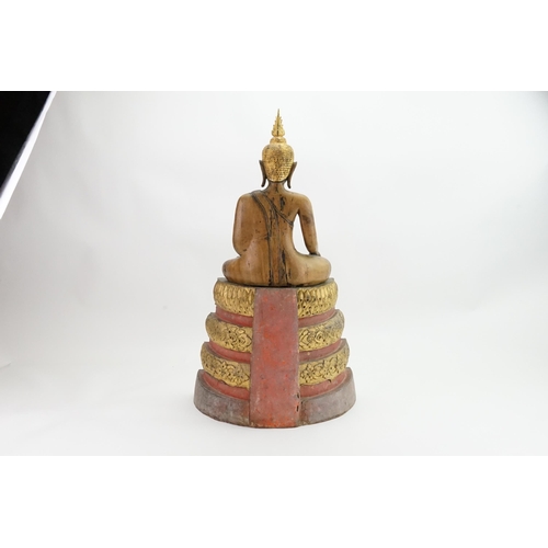 416 - An Asian Carved Wooden Seated Buddha in Wood with Gilt Highlights seated in the Lotus Position on a ... 