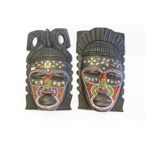 991 - A Pair of African Bead Work Carved Soft wood Face Masks of Warriors.