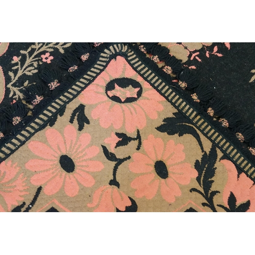 733 - A Belgian made Floral decorated Black & Pink Ground Rug with a fringed edge. Measuring: 175cms x 137... 