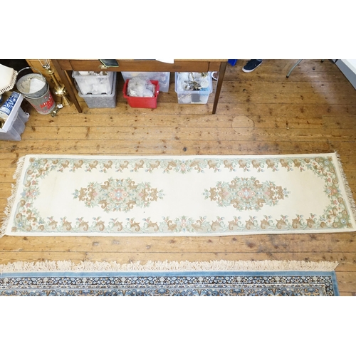 731 - A Beige Ground Floral edged Runner with a stitched edge. Measuring: 325cms long x 82cms across.