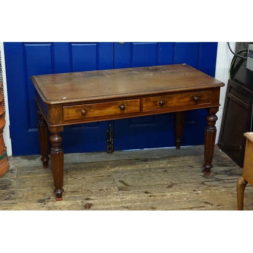 712 - A Victorian Mahogany Two Drawers Dressing Table resting on turned legs with fluted decoration. Measu... 