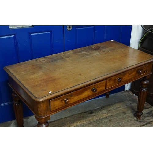 712 - A Victorian Mahogany Two Drawers Dressing Table resting on turned legs with fluted decoration. Measu... 