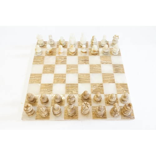 581 - An Onyx & Marble Chess Set of turned form. Board Measuring: 44cms x 44cms.