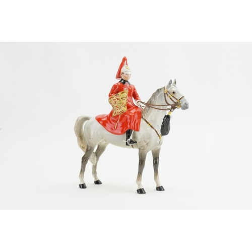 1054 - A Beswick Lifeguard Solider seated on his dappled grey horse, model no. 1624.