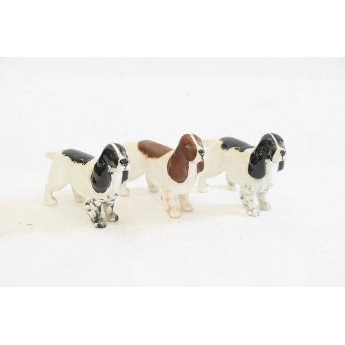 1058 - Three Beswick Dogs to include two in glaze & one in buff.