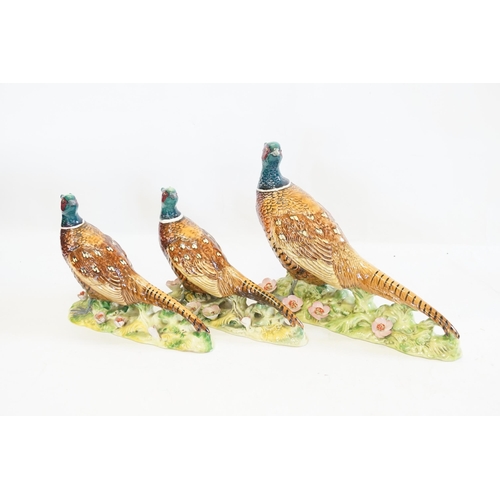 1061 - Three various Beswick Studies of Pheasants on flower encrusted Bases. Model No: 1225/1226 x2. Patent... 