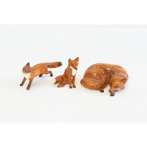 1079 - Three various Beswick Studies of Foxes seated, Recumbent & On Alert.