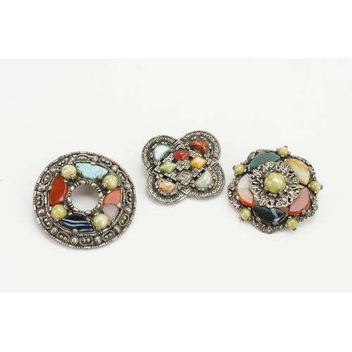 184 - A set of three Scottish pebble style pin brooches.