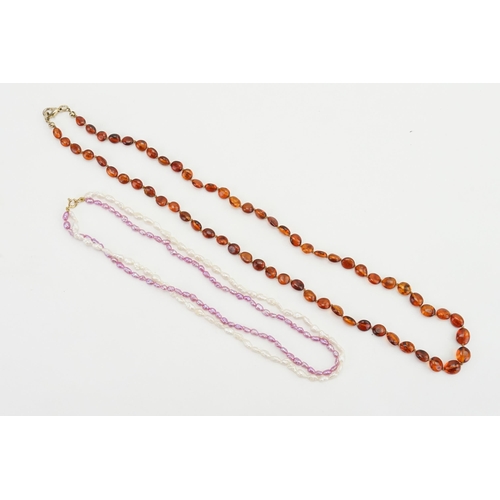 138 - A amber style bead necklace, along with a 9ct gold clasp pearl necklace.