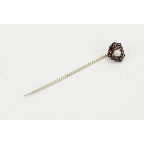 156 - A garnet and pearl set stick pin.