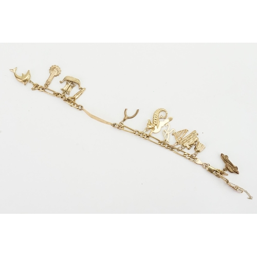 153 - A 9ct gold bracelet, hung with various gold charms, to include boat, key, car, train etc. Weight 11.... 