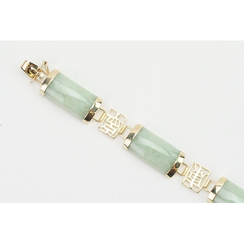 164 - A 9ct gold Jade set Chinese bracelet. Weight 12g.