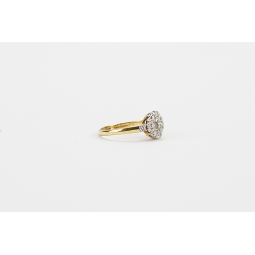 166 - A 18ct yellow gold diamond set ring, in the floral formation. Set with 11 diamonds. Centre stone app... 