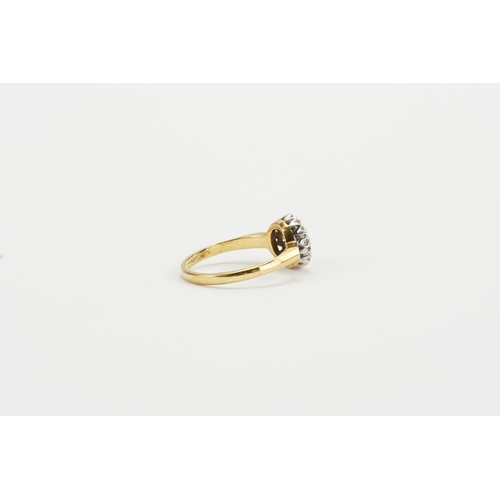 166 - A 18ct yellow gold diamond set ring, in the floral formation. Set with 11 diamonds. Centre stone app... 