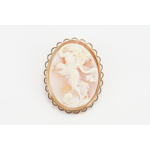 241 - A 9ct gold cameo brooch, depicting a nude lady with flowers. Measures 3.4cm x 4.4cm. Weight 15g.