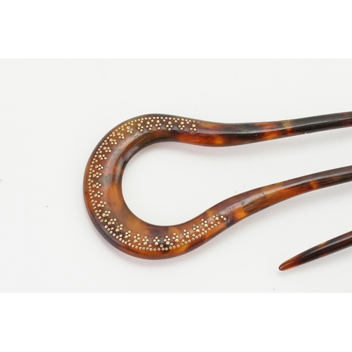 247 - A pair of Victorian tortoise shell hair pins, decorated with gold coloured inlay20.