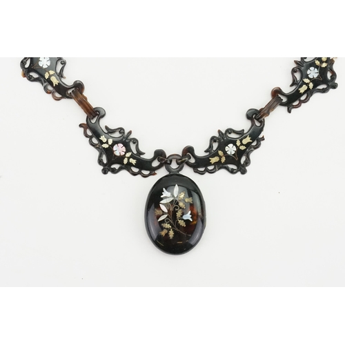 248 - A unique tortoise shell pique designed necklace, with mother of pearl inlay decoration.