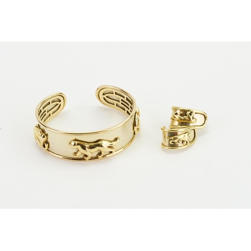 219 - A 9ct yellow gold & Gold Plated bangle and matching earrings, decorated with a panthers and elephant... 