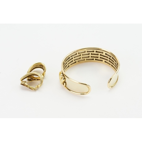 219 - A 9ct yellow gold & Gold Plated bangle and matching earrings, decorated with a panthers and elephant... 