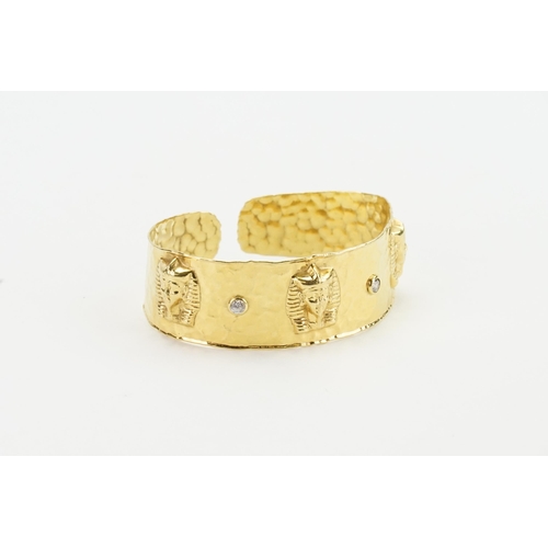 223 - A Egyptian style gold plated paste set bracelet.