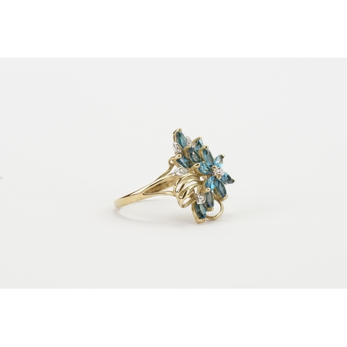 210 - A 9ct gold chip diamond and blue stone set ring, in the floral design. Weight 4.4g.