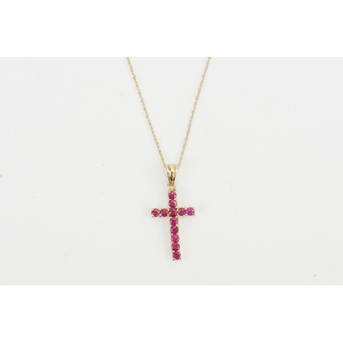 207 - A 9ct gold pink stone set cross, hung on a 9ct gold chain. Weight 1.3g.