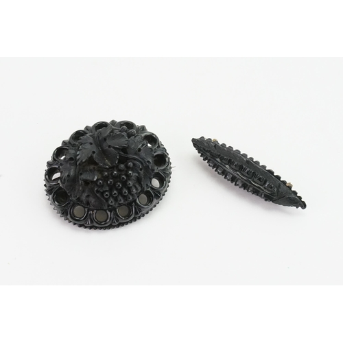 198 - Two carved Jet brooches, possibly Whitby Jet. 22.9g.