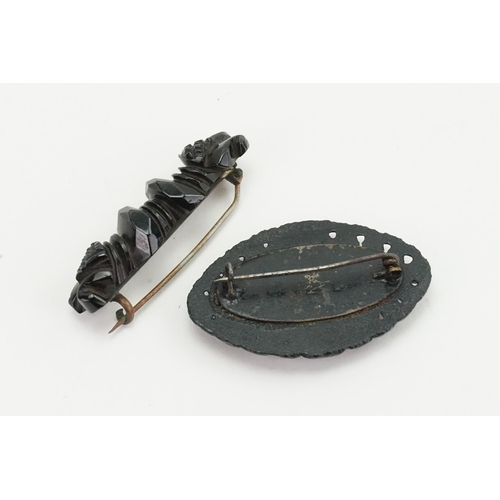 199 - A carved Jet brooch along with one other. Weight 13g.