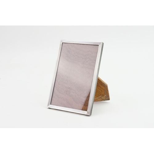 65 - A silver mounted picture frame, wooden backed.