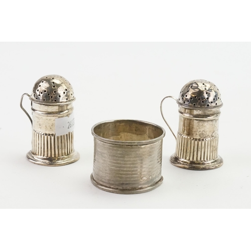 72 - A silver salt and pepper, along with a napkin rings. Weight 63g.