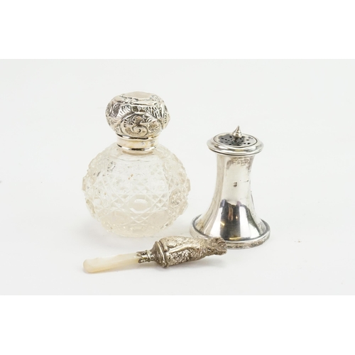 81 - A silver salt, along with a mother of pearl rattle, silver topped scent bottle.