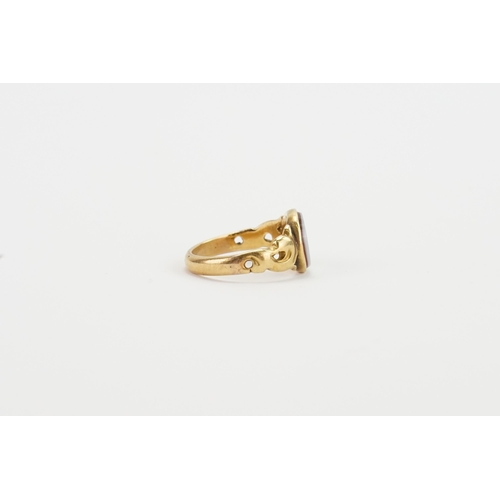 269 - A gold signet ring, tests around 14ct, set with a grey and red stone. Weight 4.5g. Size O.