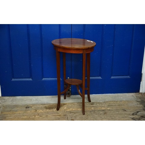 708 - An Oval Edwardian Mahogany & Satinwood inlaid Occasional Table resting on Splayed out Legs. Measurin... 