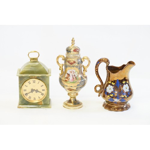 813 - A red and gilt vase, along with a copper jug and green clock.