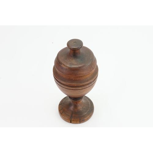 609 - A late 19th Century Turned Olive Wood Vase & Cover resting on a pedestal base. Measuring: 25cms High... 