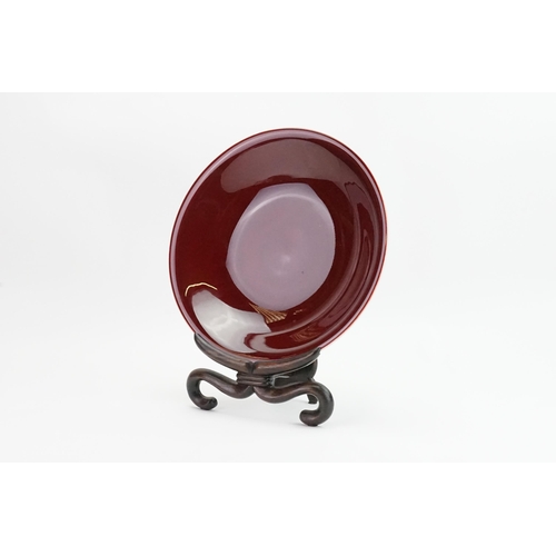 499 - A Red glazed Korean Bowl on stand. Measuring: 31cms across.