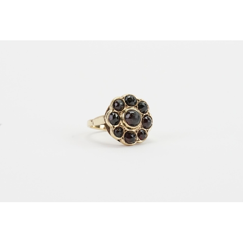 94 - A 9ct Gold Garnet Cabochon Set Ring with 9 Garnets in total. Weight: 8.5g. Size Q.