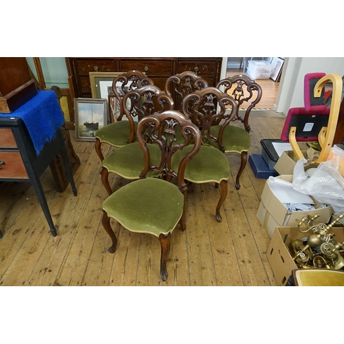 435 - A Set of Six Victorian Pierced Scroll & Floral enhanced Double Bow Back Walnut Dining Chairs resting... 