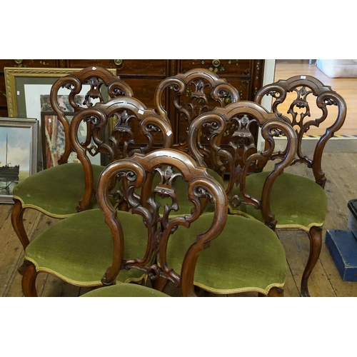 435 - A Set of Six Victorian Pierced Scroll & Floral enhanced Double Bow Back Walnut Dining Chairs resting... 